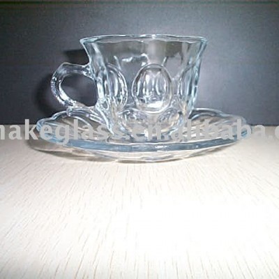 engraved glass cup and saucer